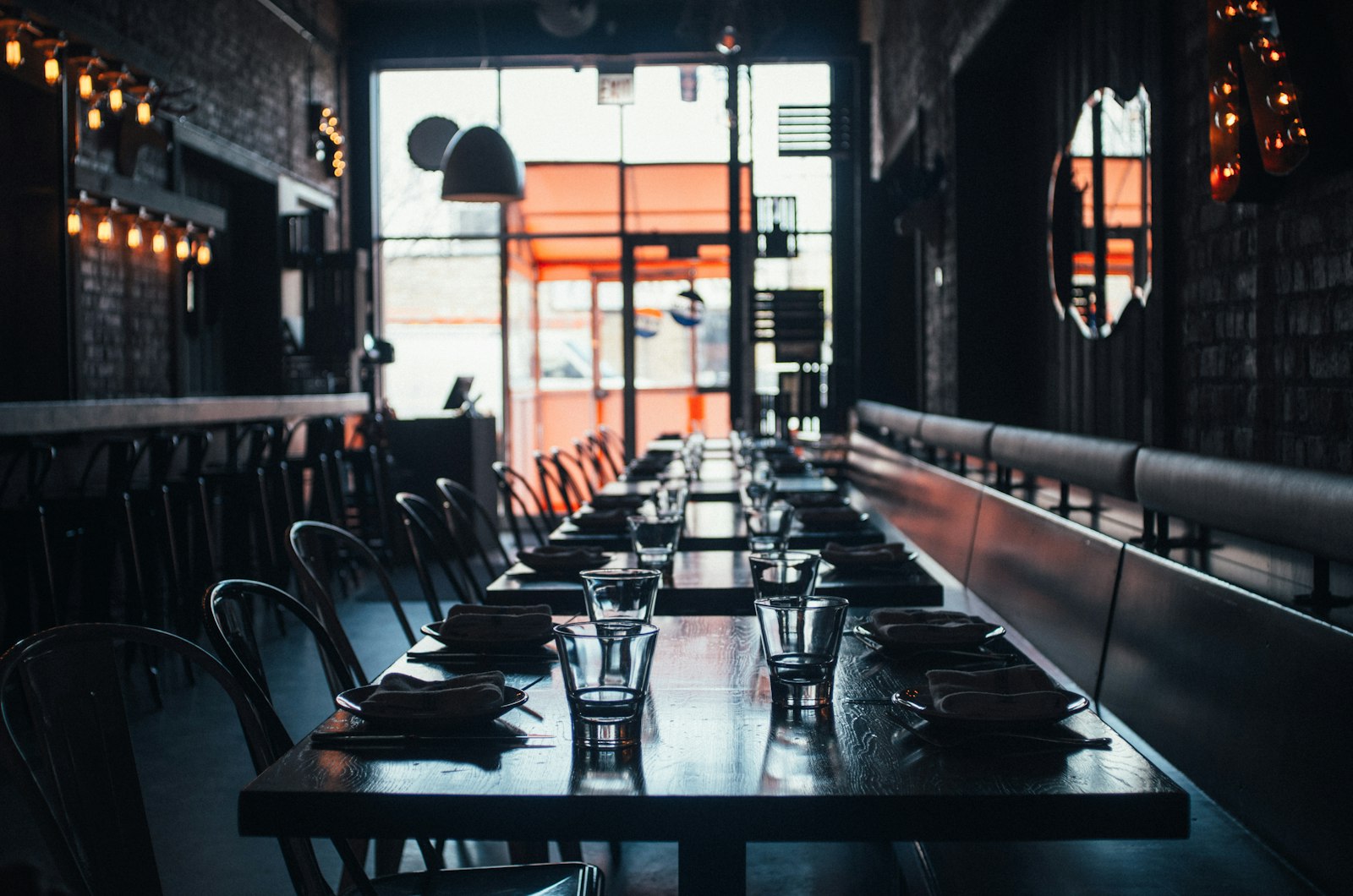 A neighborhood restaurant with a long table set for service